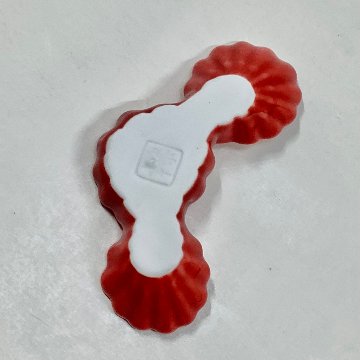 赤釉菊形箸置の画像